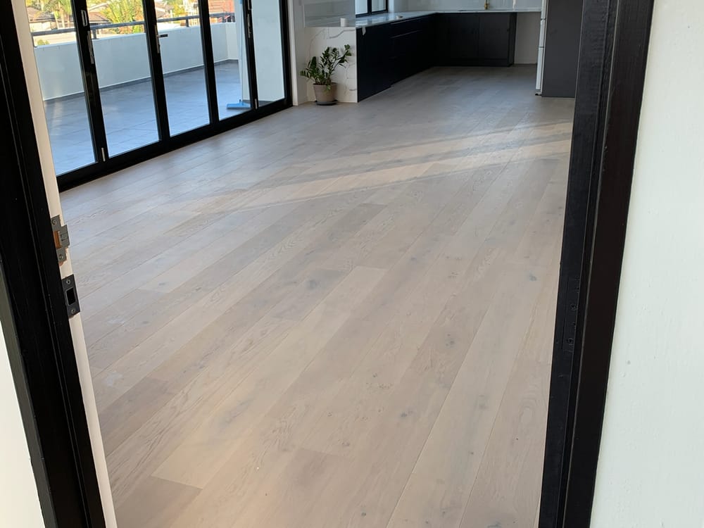 Minyama home renovated by Elite Renovations — open living with timber floors and bifold doors